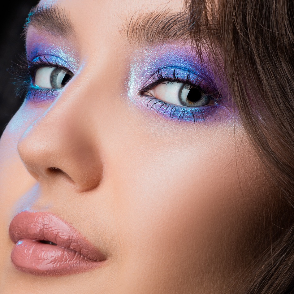 Close-up of a smooth, colour-ready 1985-style complexion with a saturated eye