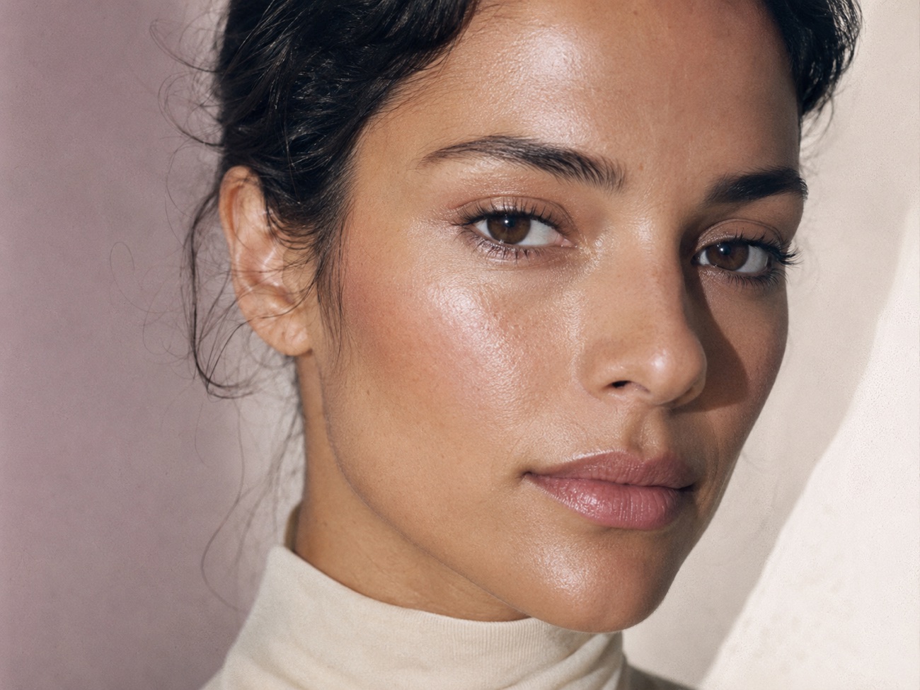 Close-up of luminous 1999 complexion — sheer base, glow on the high points, soft frost on the lid