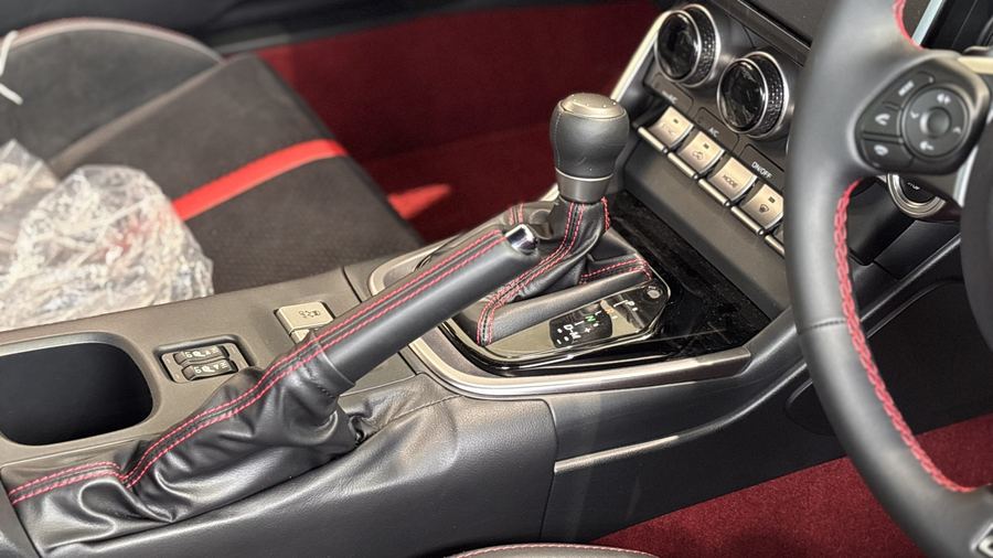 GR86 six-speed manual shifter with red contrast stitching.