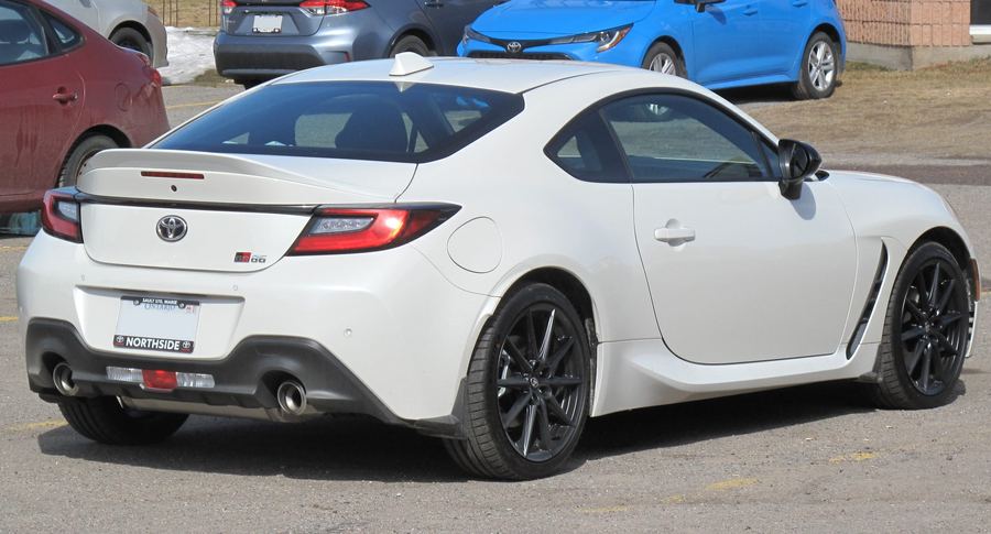 2022 Toyota GR86 in white, rear three-quarter view.