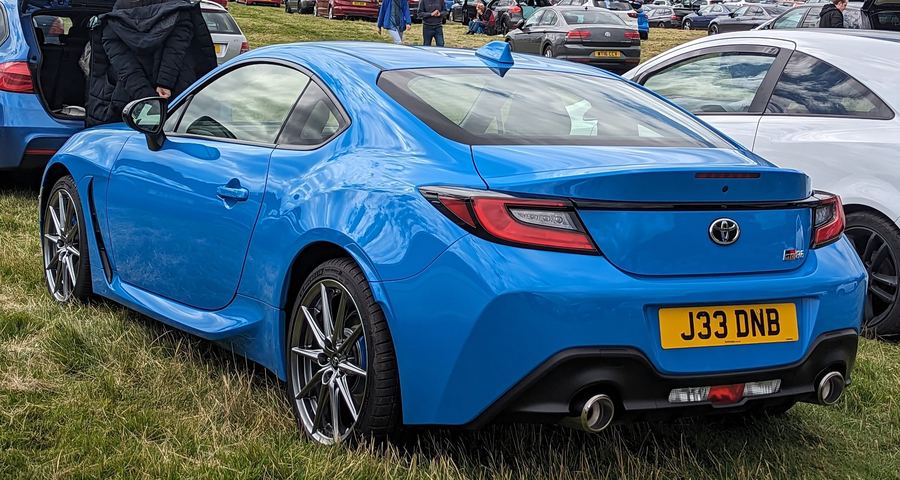 2022 Toyota GR86 in blue, rear three-quarter view.