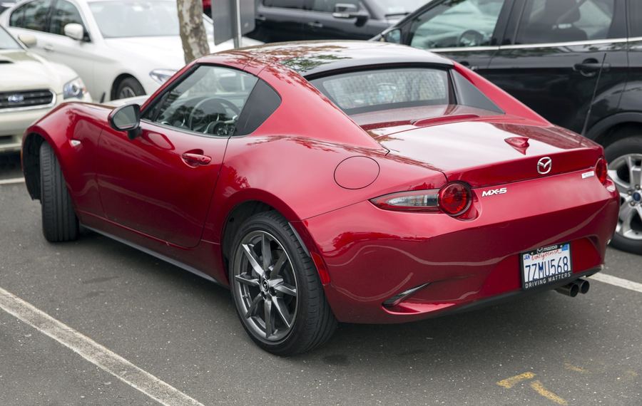 2018 MX-5 RF in Soul Red Crystal, rear three-quarter view showing the fastback roof.