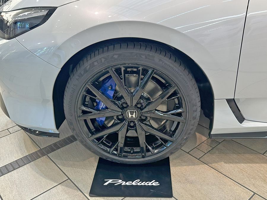 Prelude 19-inch black alloy wheel with a blue front brake caliper visible.