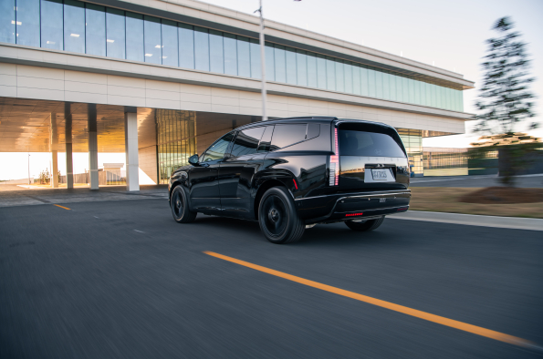 2026 Hyundai Ioniq 9 Calligraphy Black Ink in motion, rear three-quarter view.