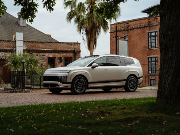 2026 Hyundai Ioniq 9 side profile, parked outside a Savannah-style townhouse.