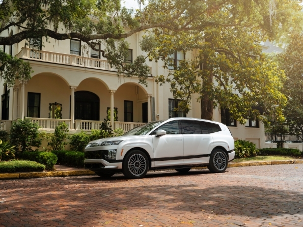 2026 Hyundai Ioniq 9 side profile, parked outside a historic mansion.