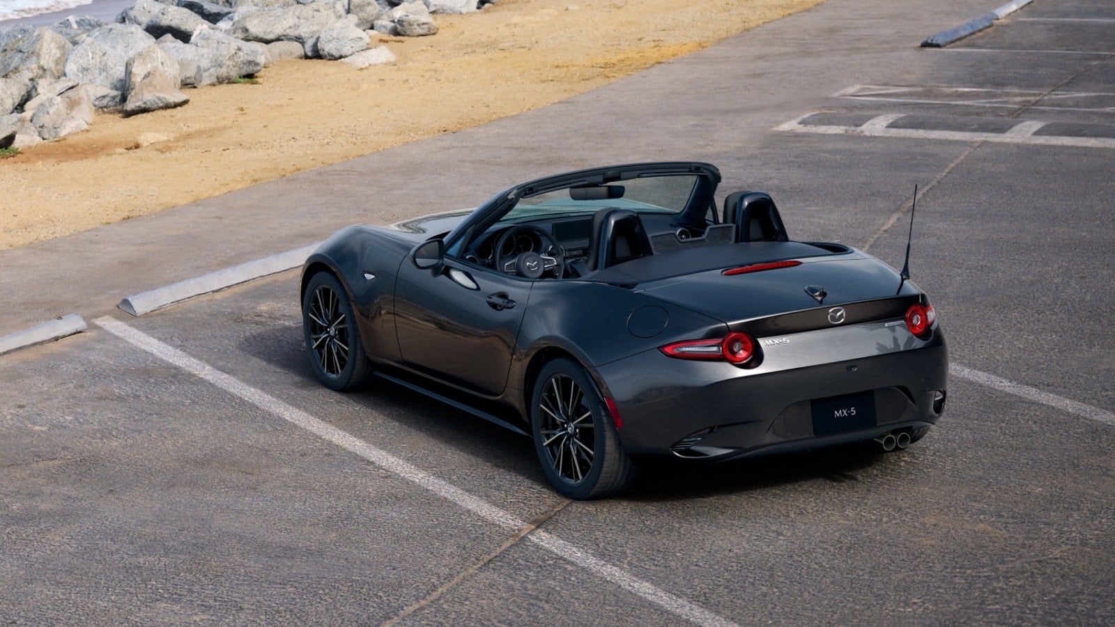 2026 Mazda MX-5 Miata driving on a winding road.