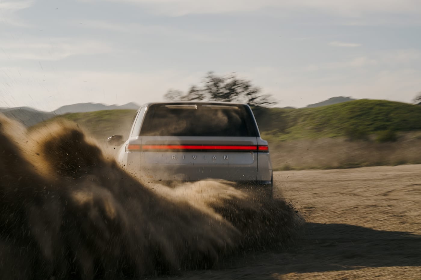 Rivian R2 electric SUV, front three-quarter, official press photograph.