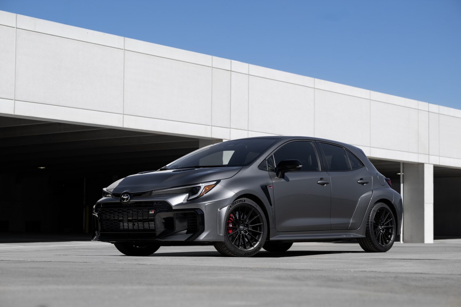 2026 Toyota GR Corolla Premium Plus in Heavy Metal, studio front three-quarter view.