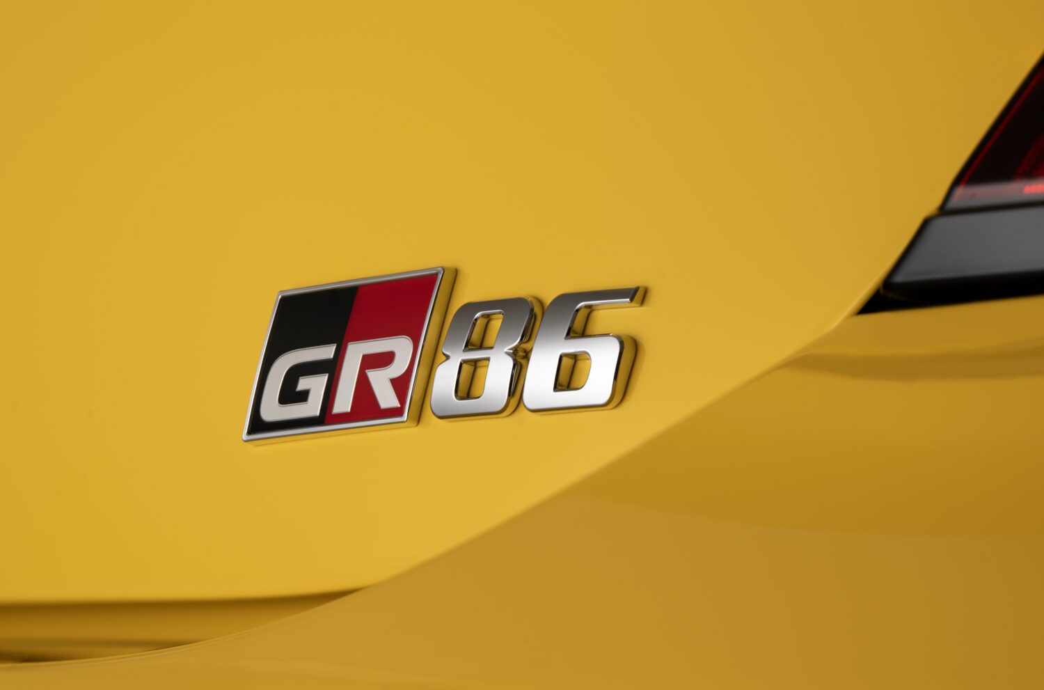 2026 Toyota GR86 Yuzu Edition interior detail, yellow stitching on steering wheel.