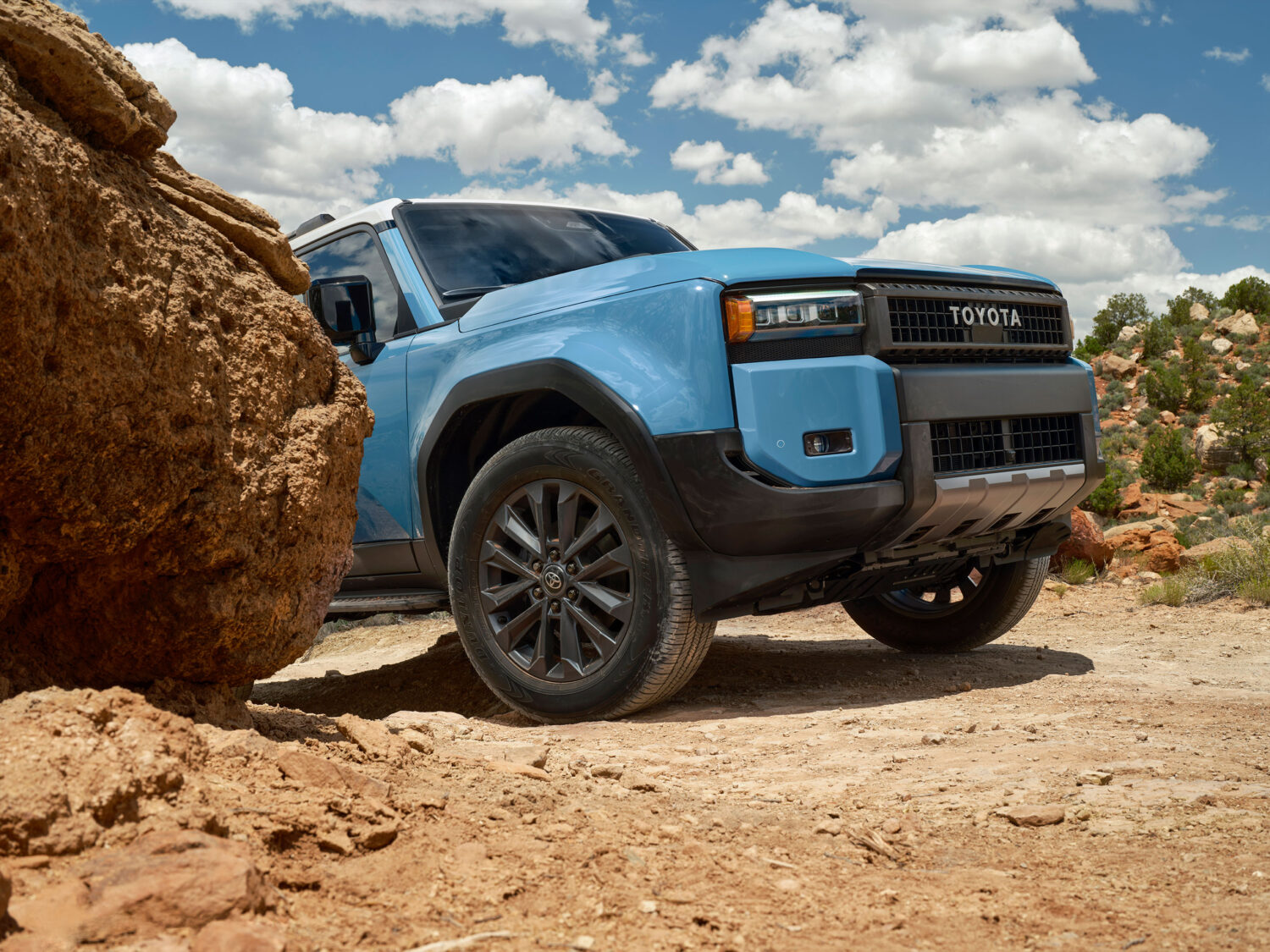 2026 Toyota Land Cruiser fording water on a trail.