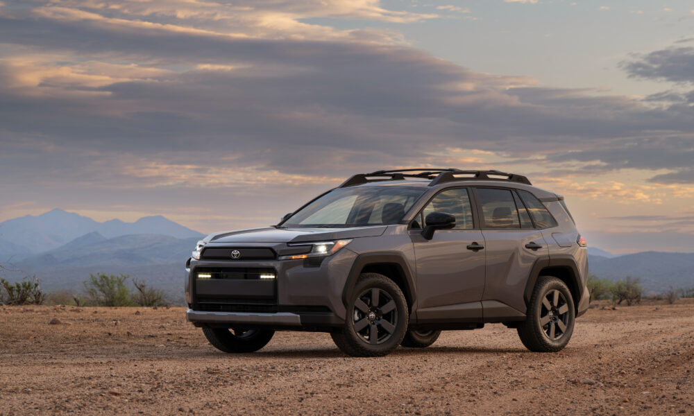 2026 Toyota RAV4 Hybrid Woodland in Urban Rock, desert overlook, official press photograph.