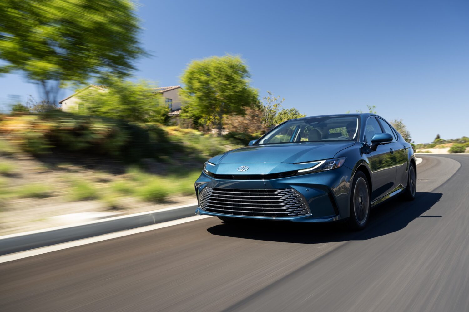 2027 Toyota Camry SE AWD, front three-quarter, official Toyota press photograph