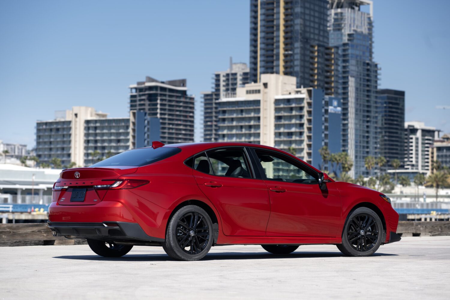 2027 Toyota Camry SE AWD, rear three-quarter, official Toyota press photograph