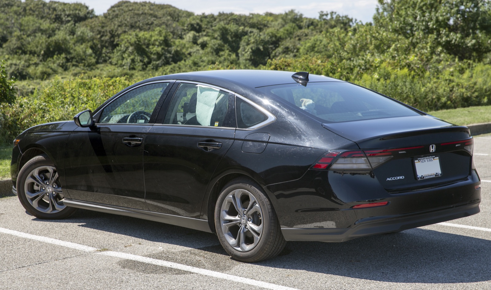 2027 Honda Accord EX in Crystal Black Pearl, rear three-quarter, real photograph.