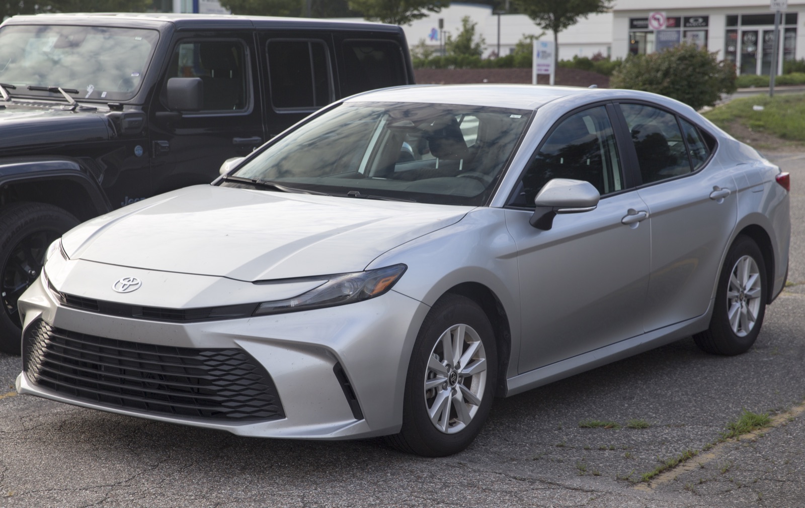 2027 Toyota Camry Hybrid LE in Celestial Silver Metallic, front three-quarter, real photograph.