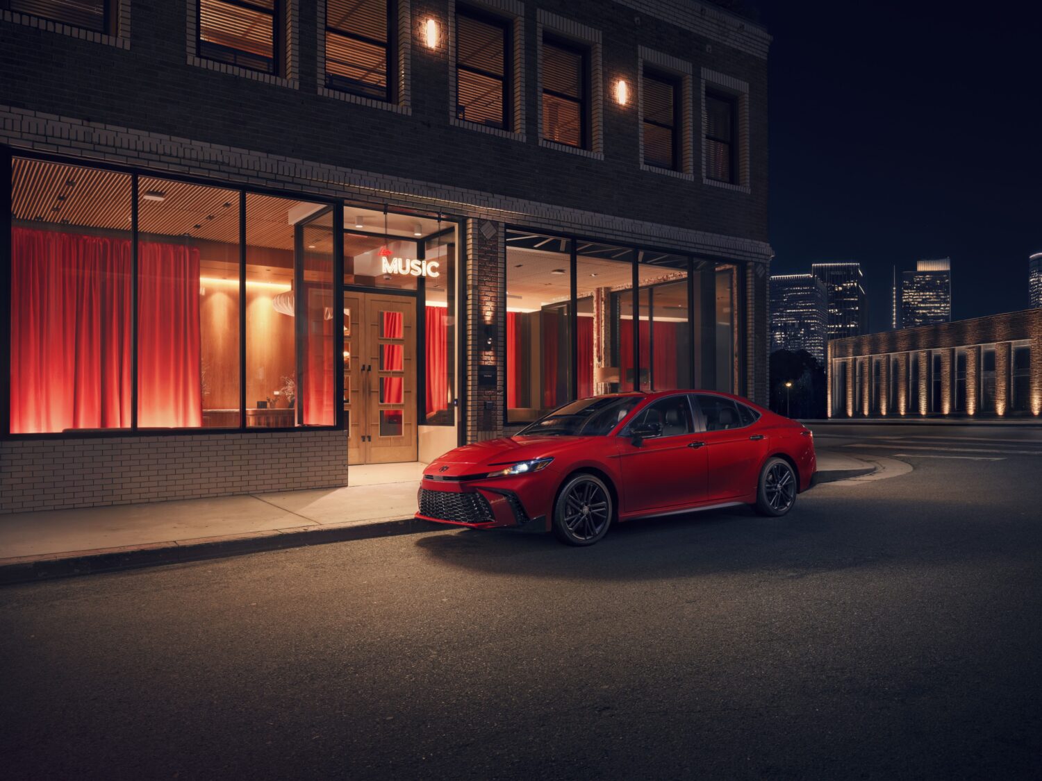 2027 Toyota Camry Nightshade Edition, front three-quarter, official Toyota press photograph.