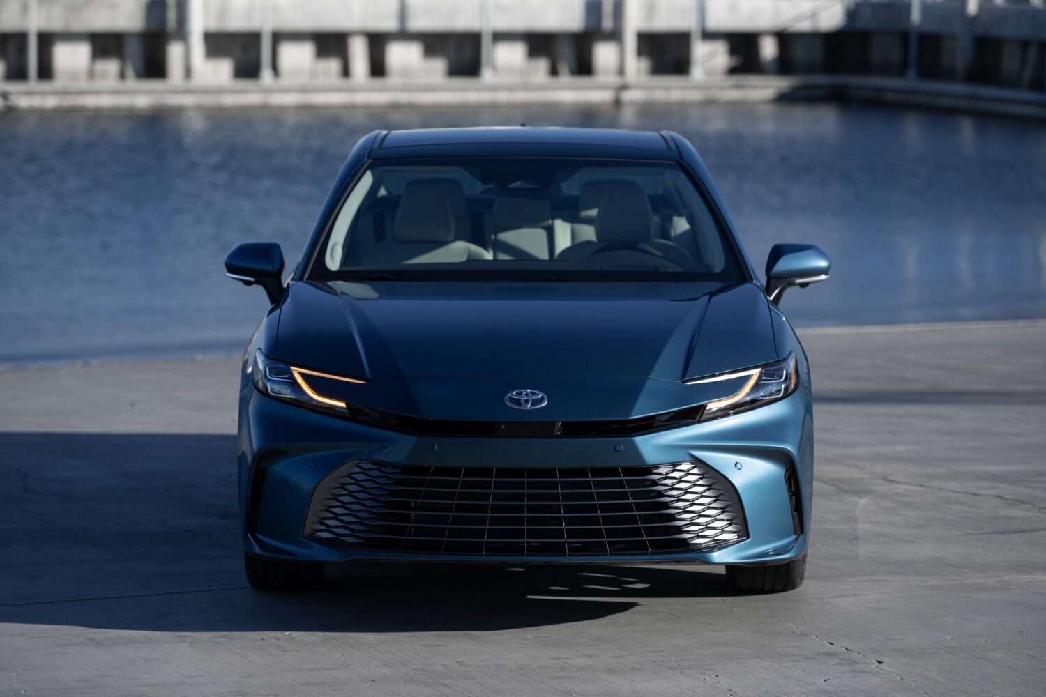 2027 Toyota Camry XLE AWD in Ocean Gem, front three-quarter, official Toyota press photograph.