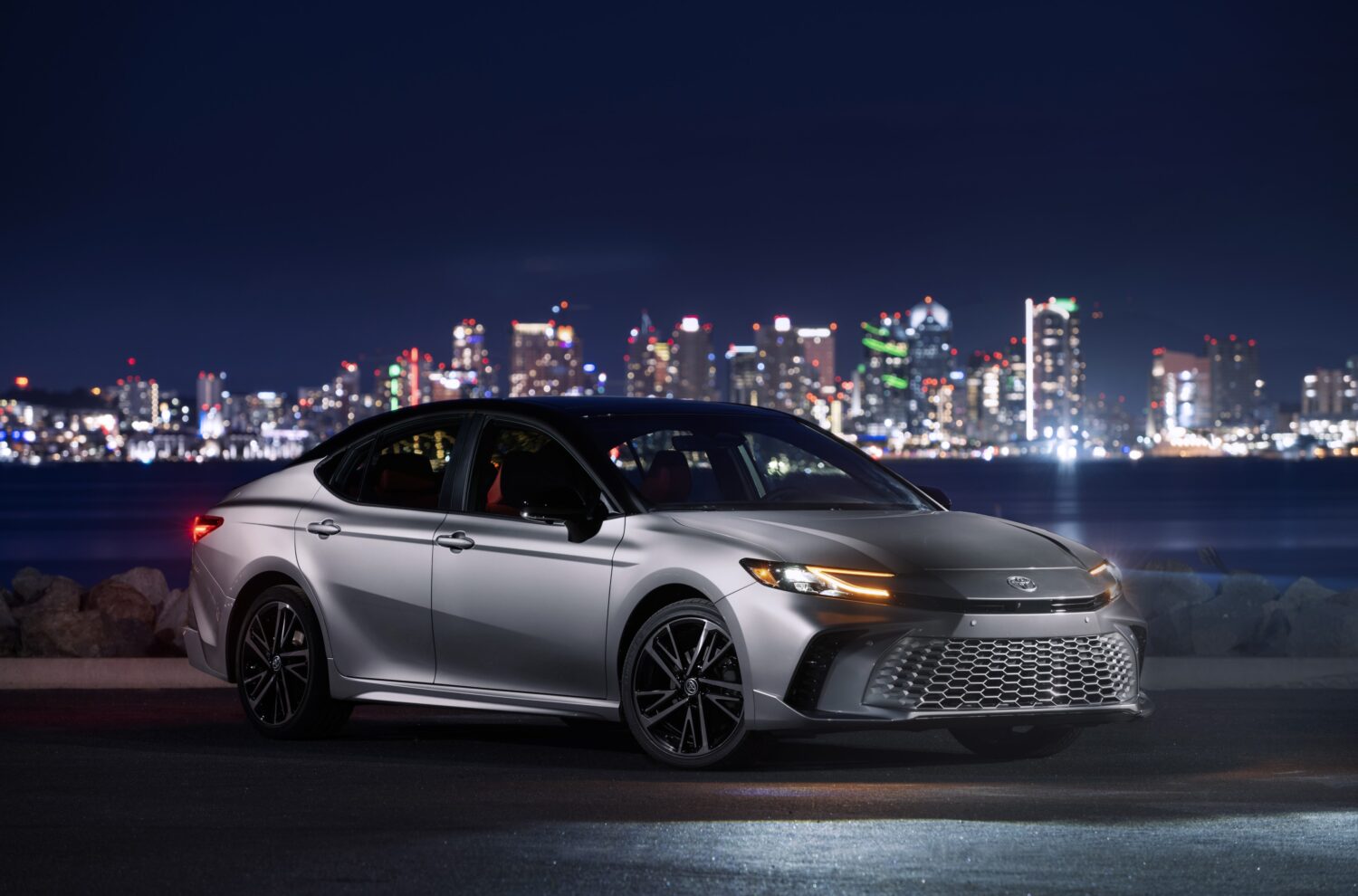 2027 Toyota Camry XSE AWD with Heavy Metal black roof, front three-quarter, official Toyota press photograph.
