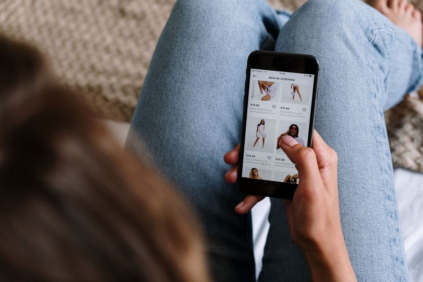 Person scrolling a shopping app on a phone