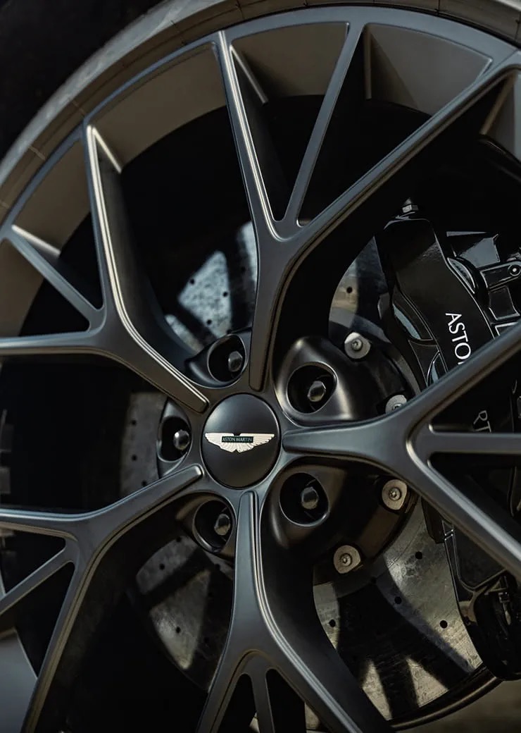 Close-up of the Aston Martin DBX707's wheel and brake caliper, badged Aston Martin.