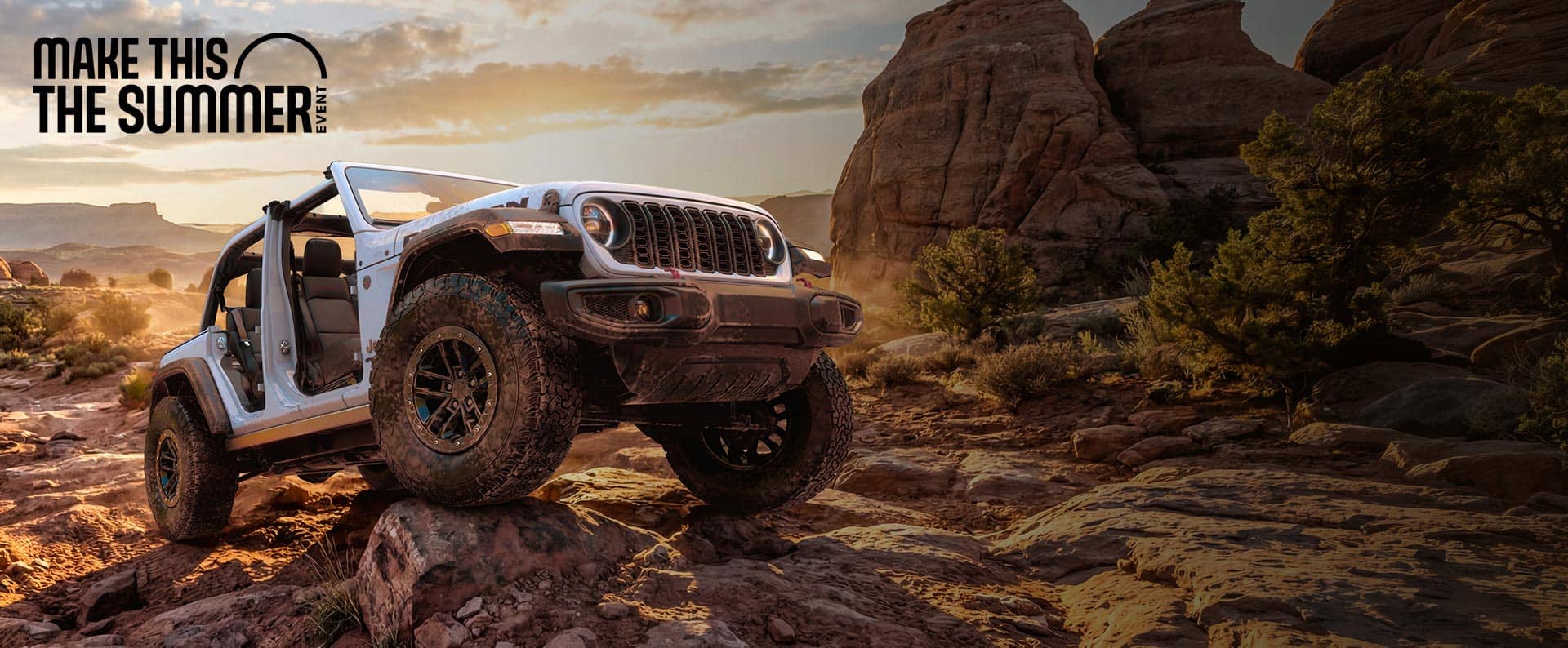 A Jeep Wrangler with 4WD climbing over rocks off-road.