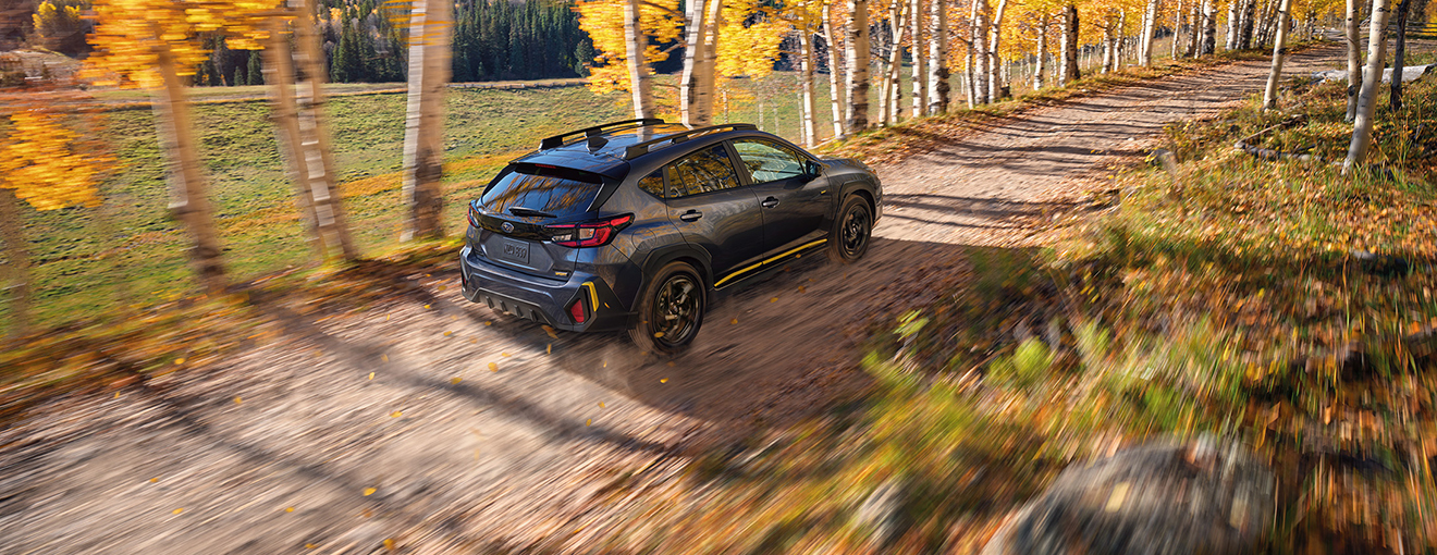 A Subaru Crosstrek with all-wheel drive on a dirt trail.