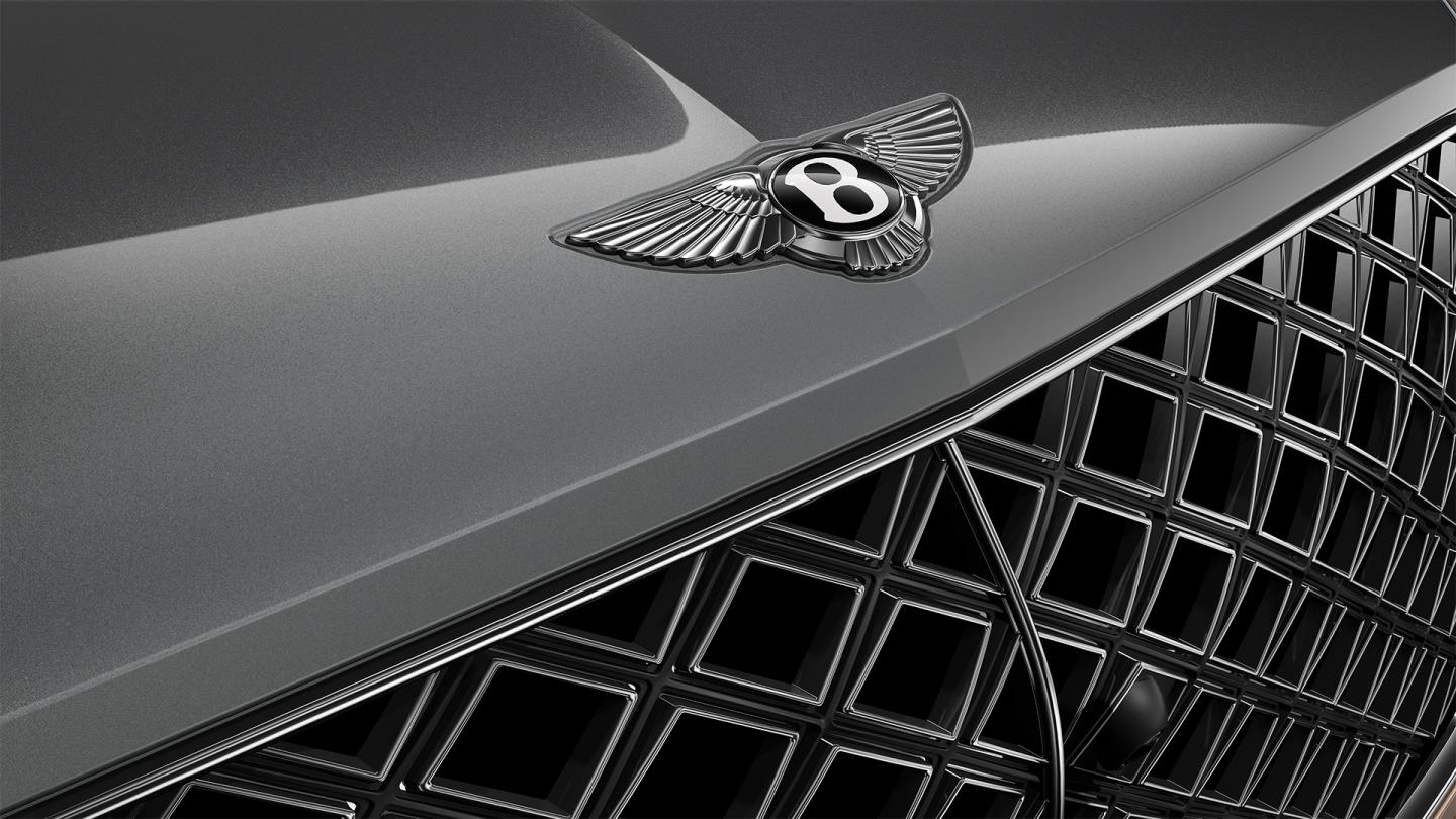 Close-up of the Bentley winged badge on the Bentayga EWB Mulliner's hood and grille.