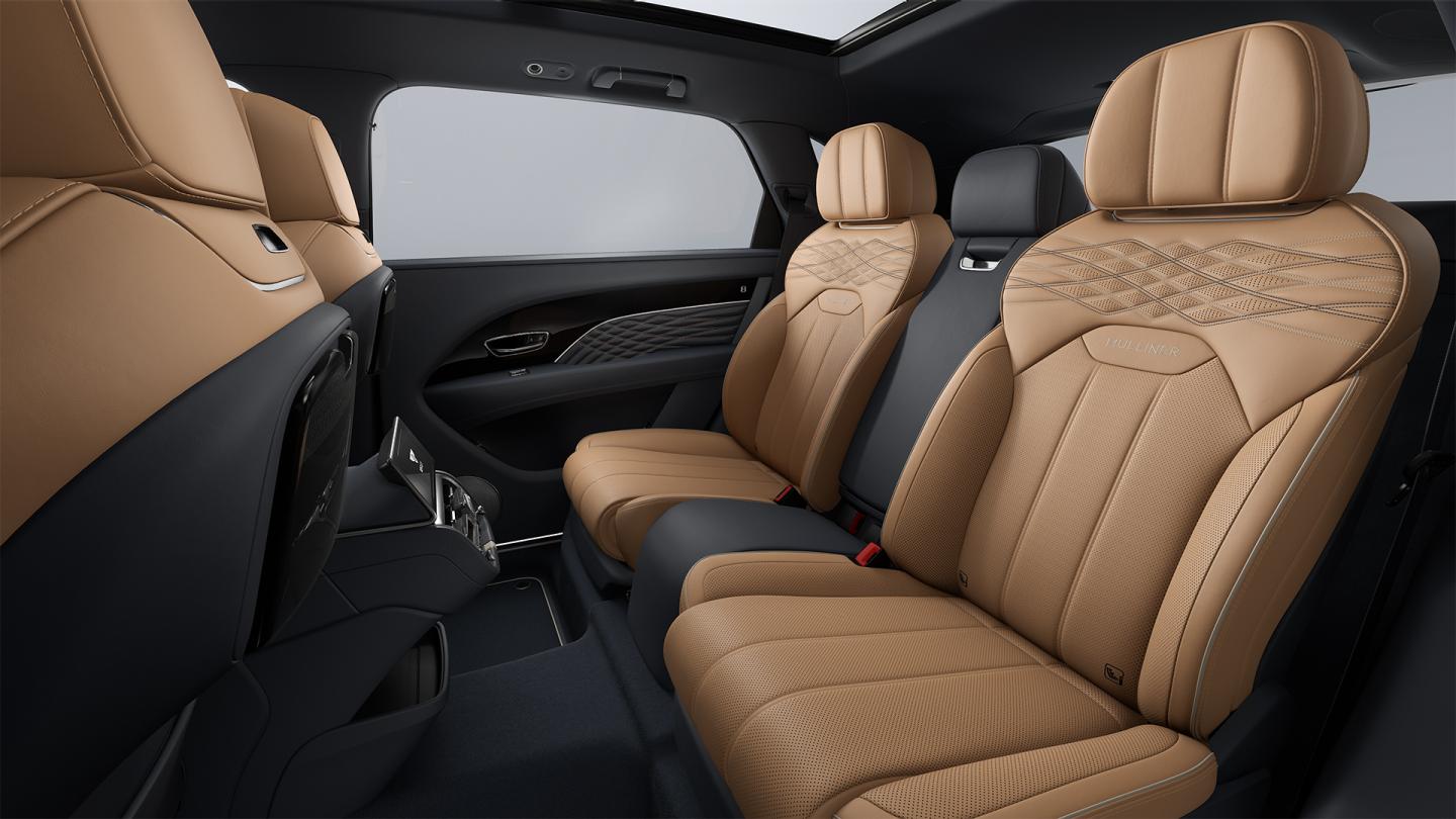 Rear cabin of the Bentley Bentayga EWB Mulliner, with tan leather captain's chairs.