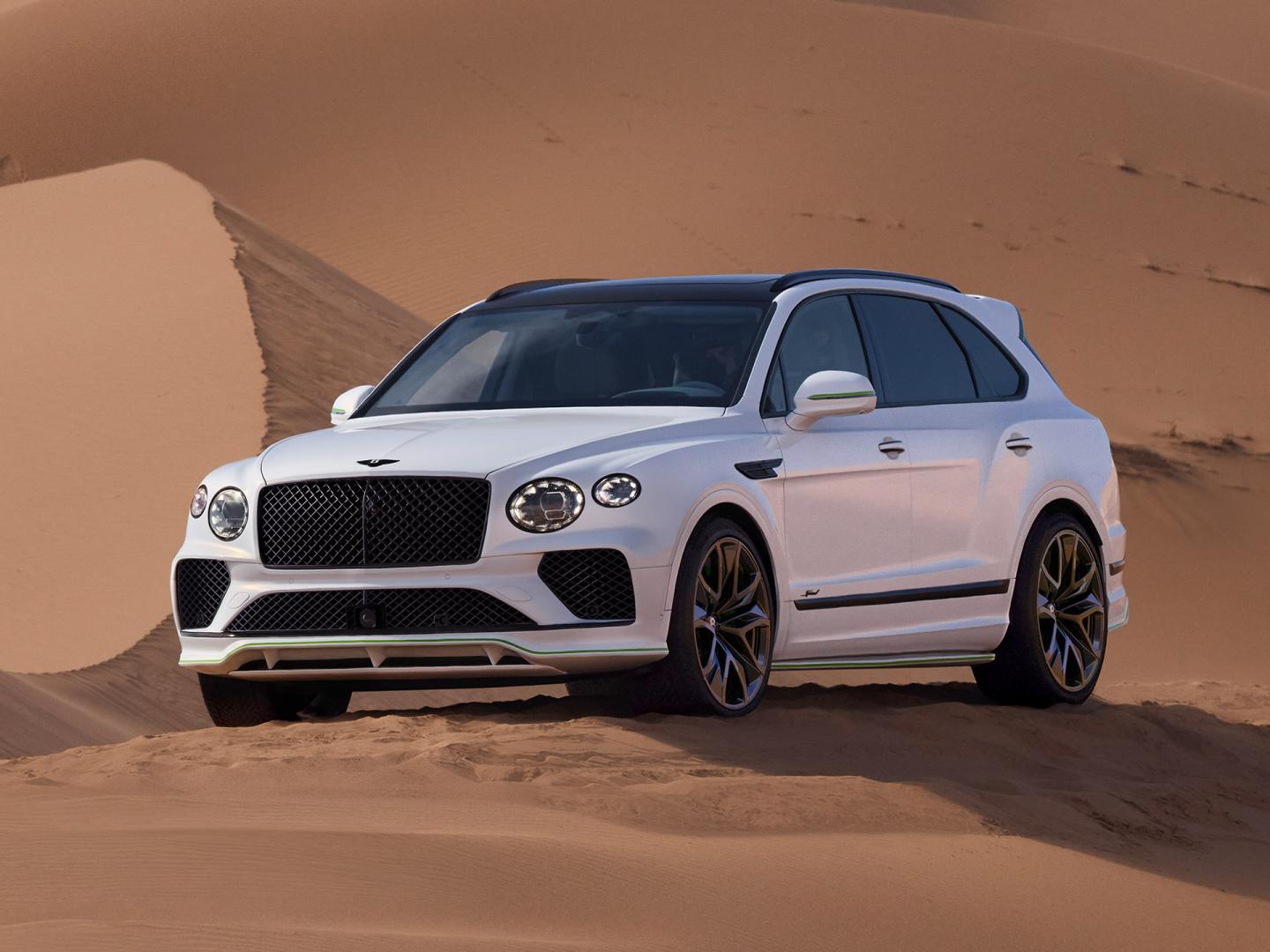 Bentley Bentayga Speed, front three-quarter view, parked on a sand dune.