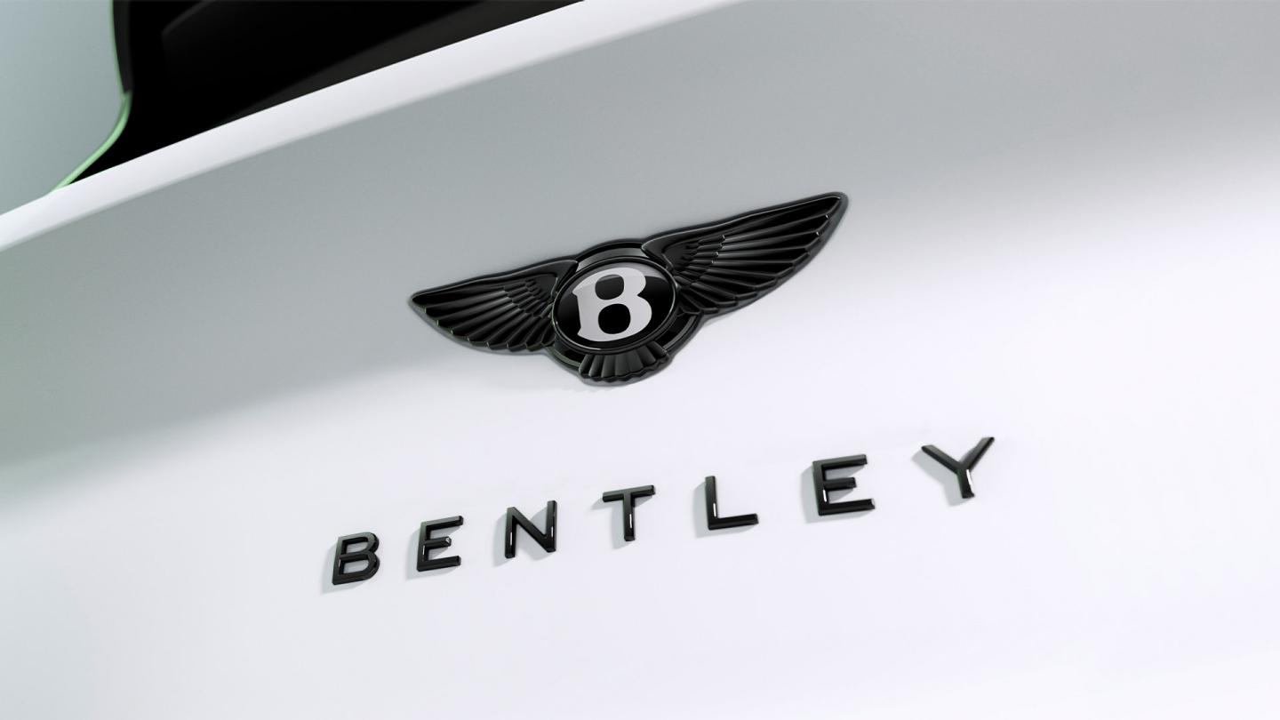 Close-up of the Bentley winged badge and Bentley script on the Bentayga's bonnet.