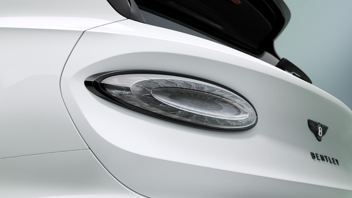 Close-up of the Bentley Bentayga's headlight and rear badge detail.