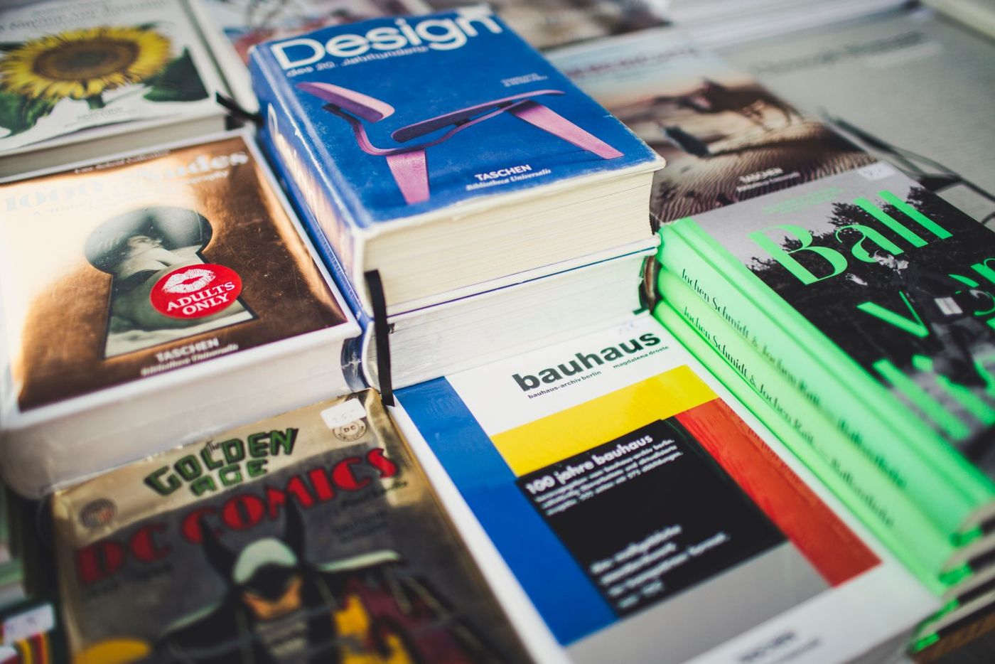 Stacks of large art and design books on display at a book stall