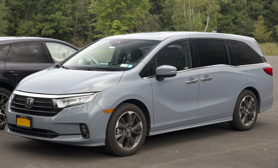 2024 Honda Odyssey Elite in Sonic Gray Pearl, front three-quarter view.