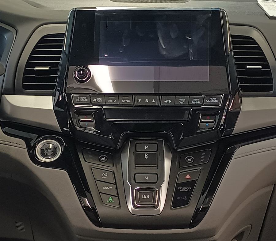 Detail crop of the Odyssey center stack with real climate buttons and push-button shifter.