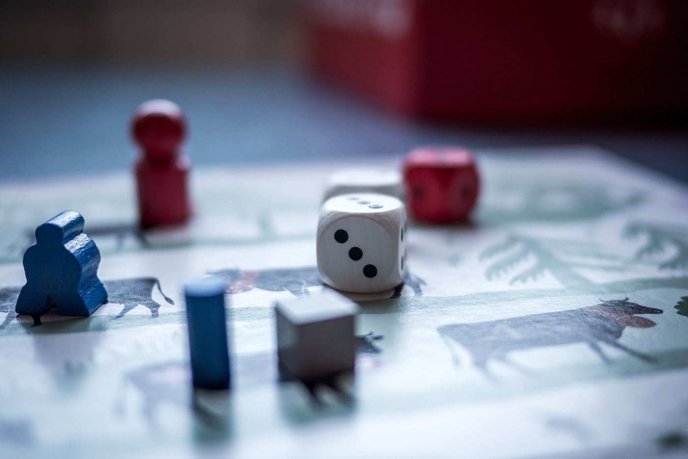 Board game pieces and dice on a printed game board
