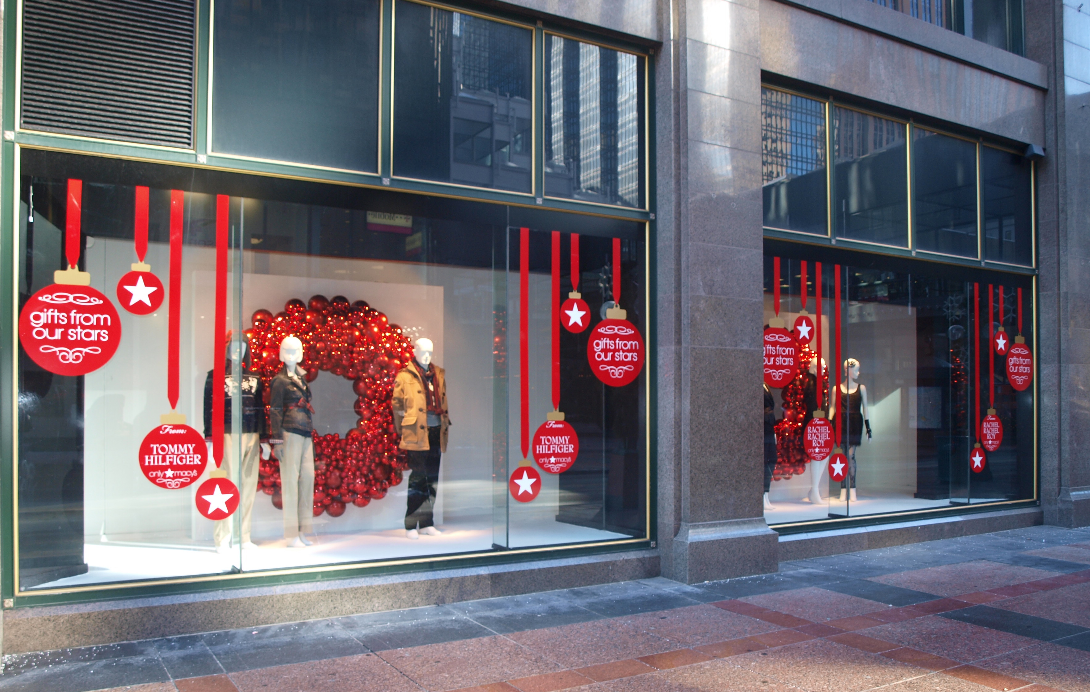 A department store storefront decorated for the holiday season, real photograph.