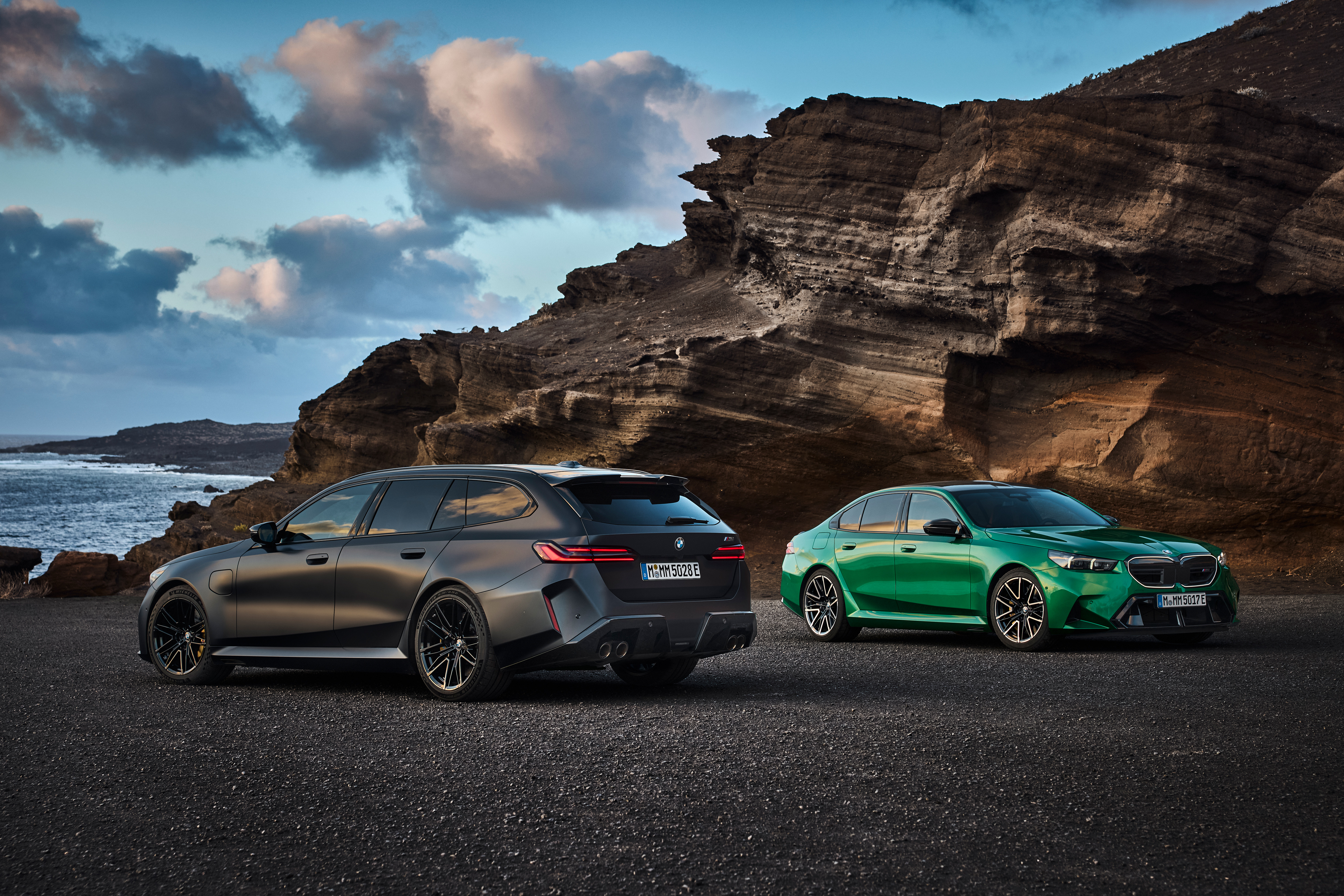The BMW M5 sedan and M5 Touring wagon parked together.