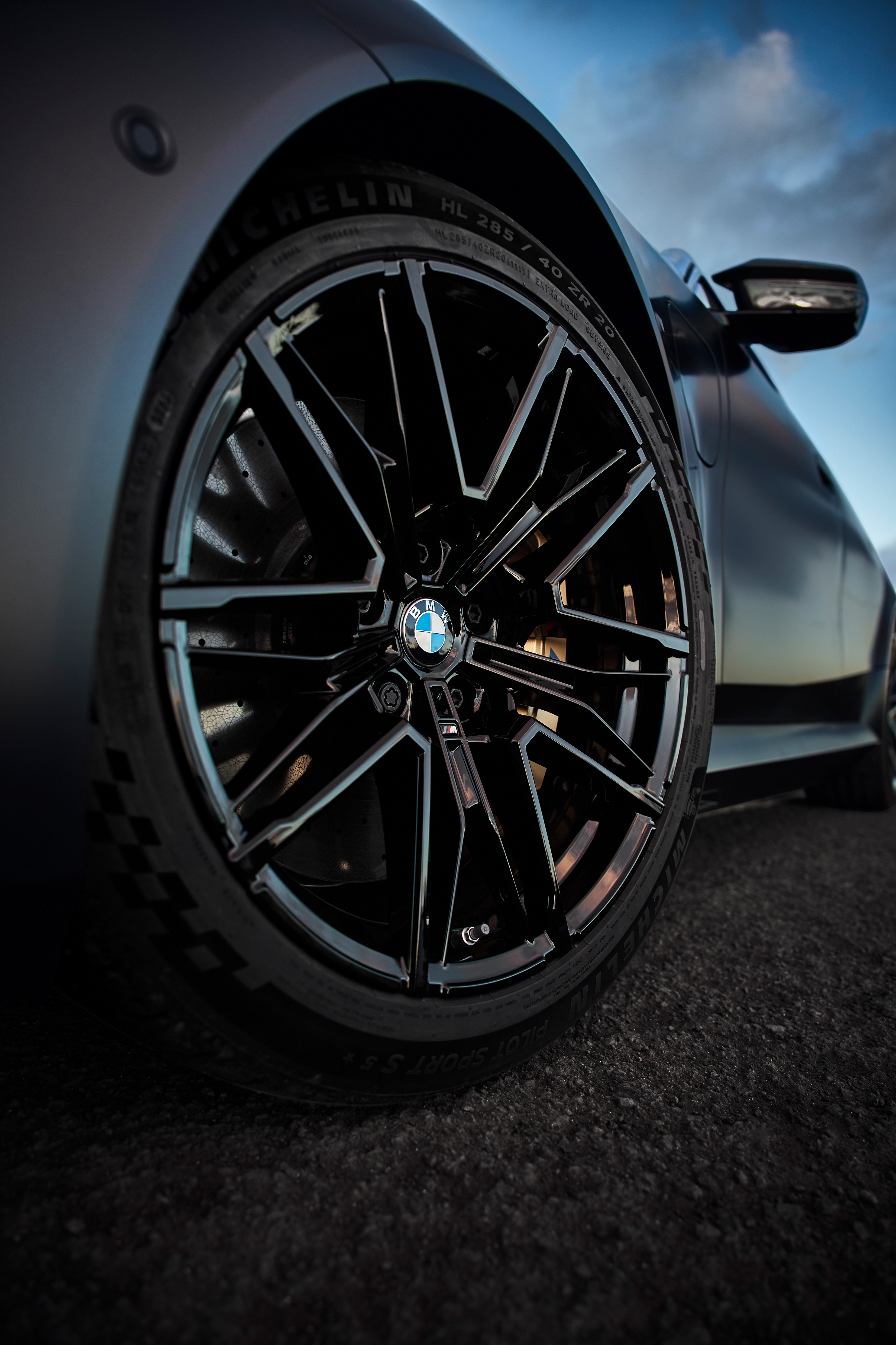 Close-up detail of the BMW M5's front wheel and brake caliper.
