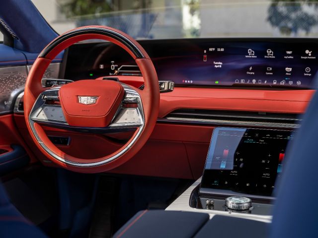 Cadillac Celestiq dashboard and curved display, with red leather steering wheel and trim.