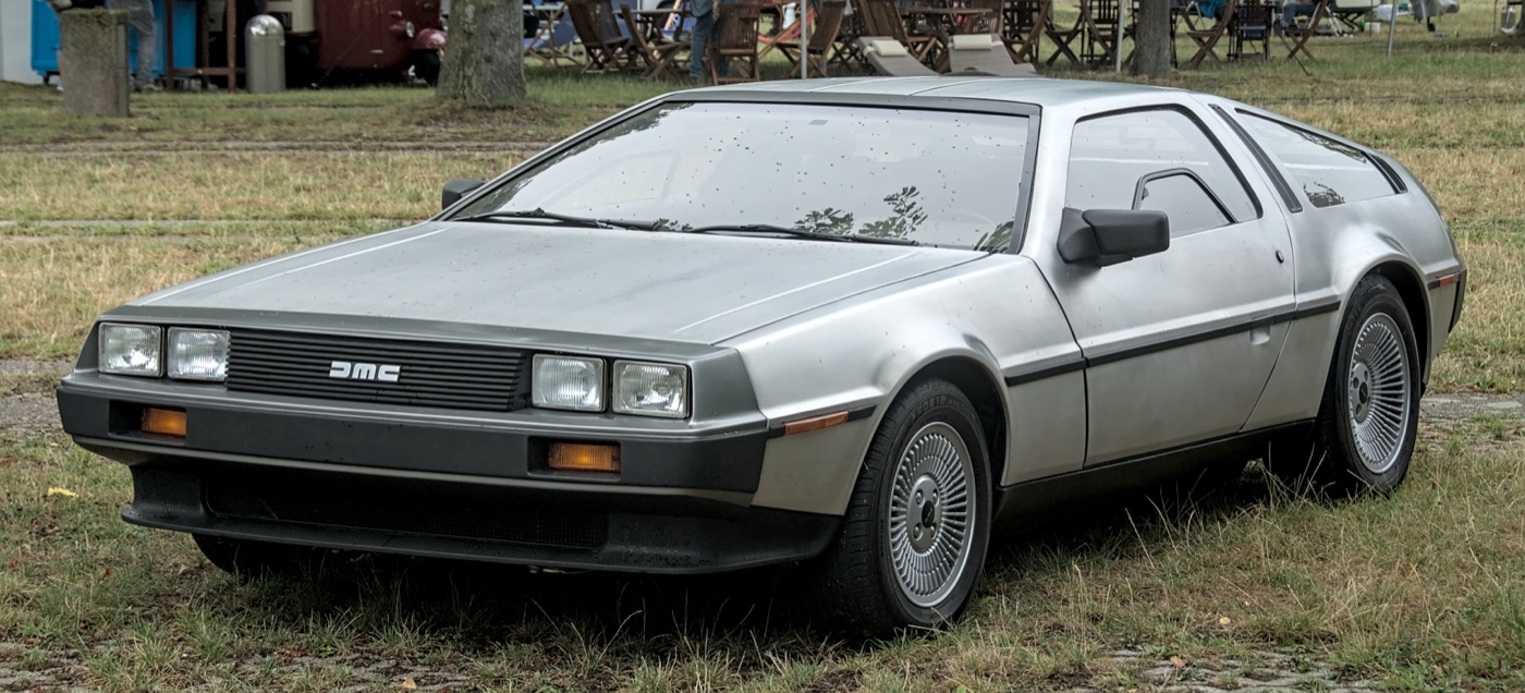 A DeLorean DMC-12 at a classic car show, real photograph.