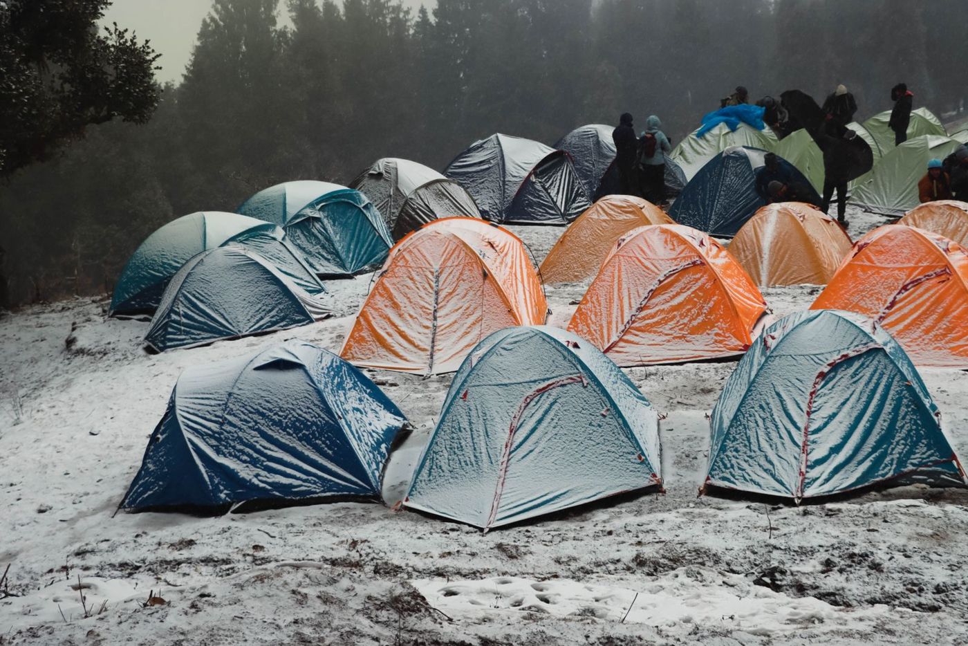 Snow-dusted tents on a cold hillside