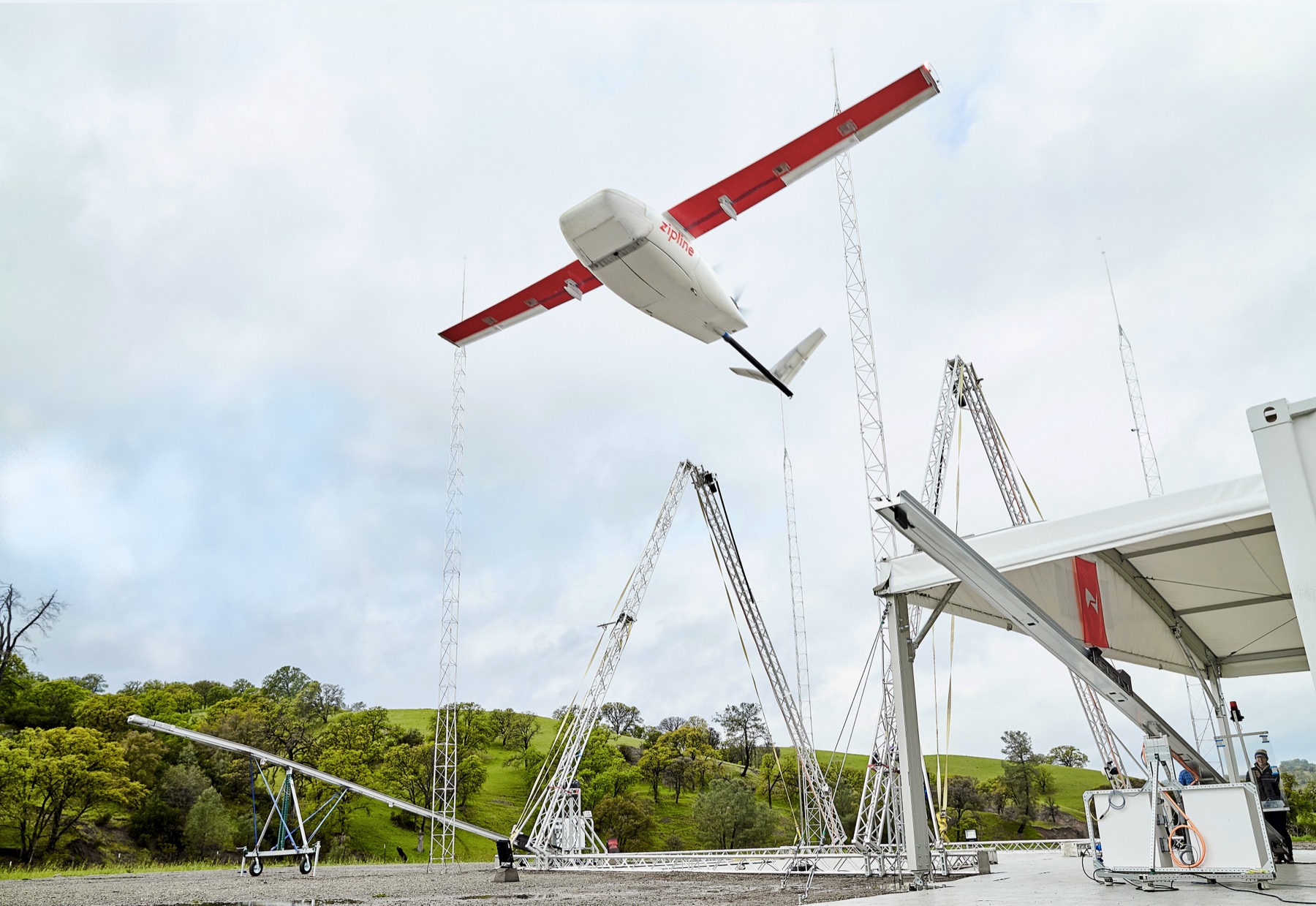 A Zipline delivery drone launching from its rail, real photograph.