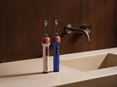 Dyson CameraJet electric toothbrush, two colorways on a bathroom counter, official Dyson press photograph.