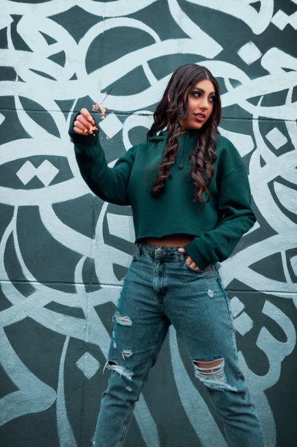 deep moss green sweater styled with dark denim outdoor