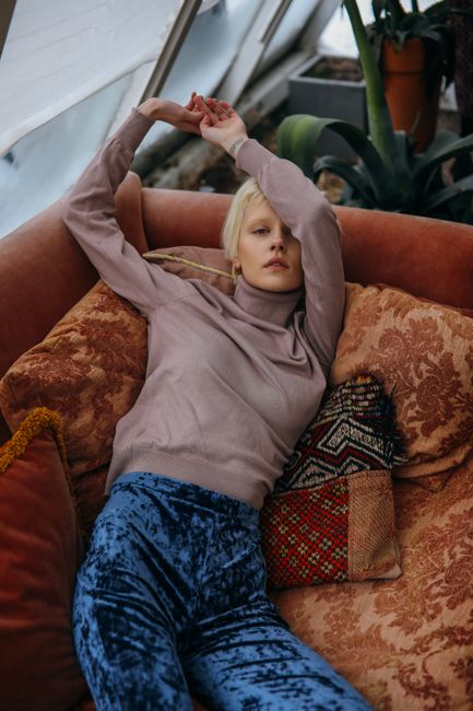 butterscotch color turtleneck styled with trousers