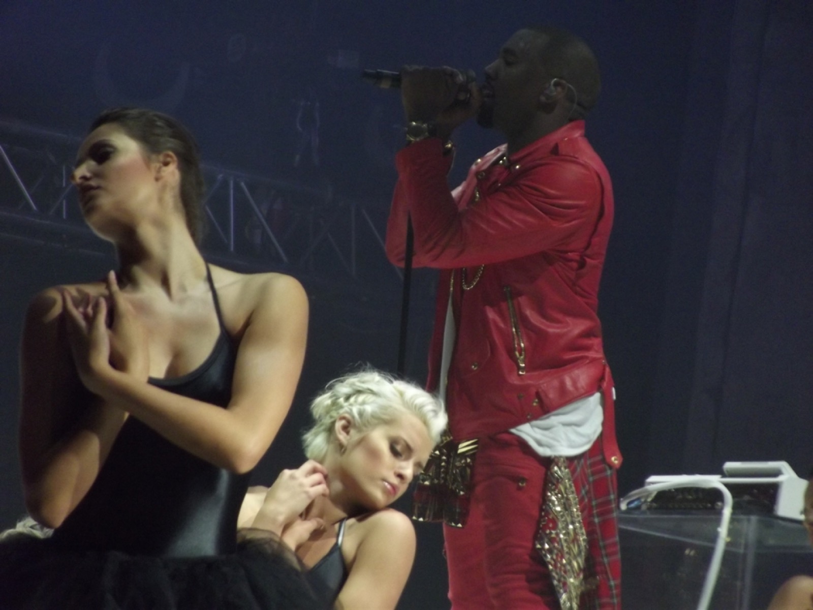 Kanye West performing in a red leather jacket at the Coke Live Music Festival, 2011