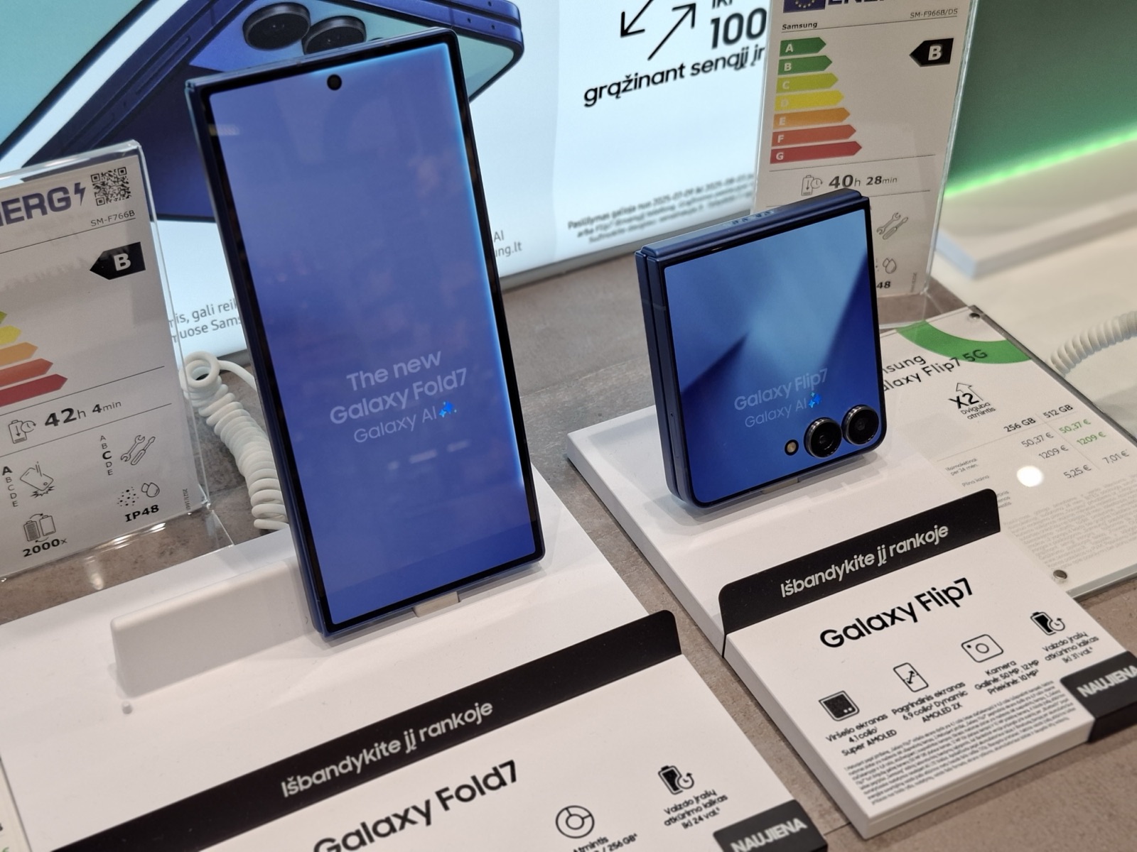 A Samsung Galaxy Z Fold7 and Galaxy Z Flip7 on display in a phone store, real photograph.