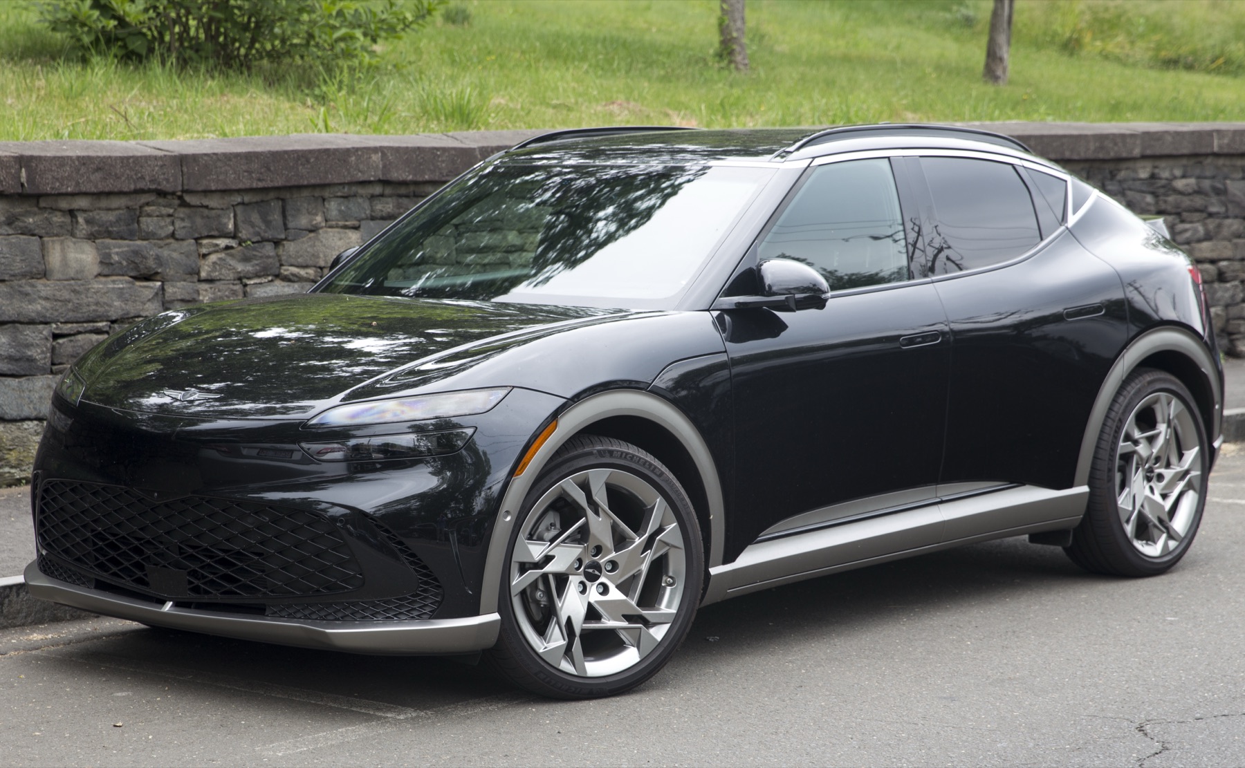 Genesis GV60 in Vik Black, front three-quarter view.
