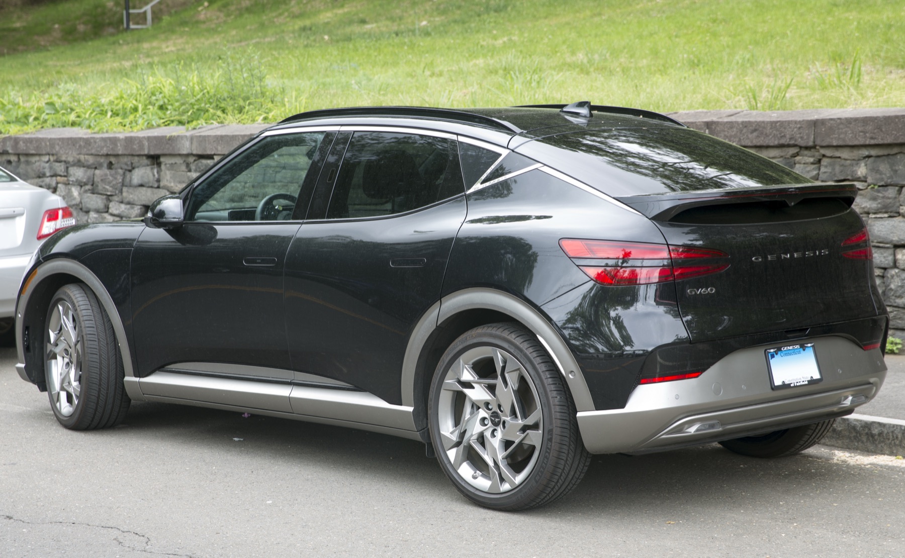Genesis GV60 in Vik Black, rear three-quarter view, Connecticut.